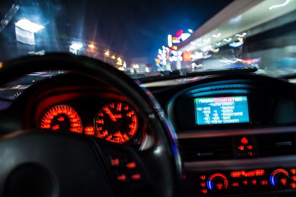 drunk driver goes down a road at night. view from inside the vehicle in the driver's seat, with blurry vision to indicate impairment.